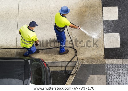 sweeper workers cleaning street road