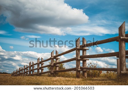 Wooden Rustic Fence In Village And Blue Sky With Clouds Wooden Rustic Fence In Village And Blue Sky With Clouds