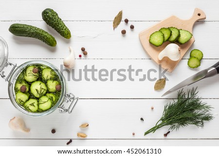 Cucumbers ready for pickling and ingredients on white table with copy space. Homemade vegetable canning. Flat lay, top view.