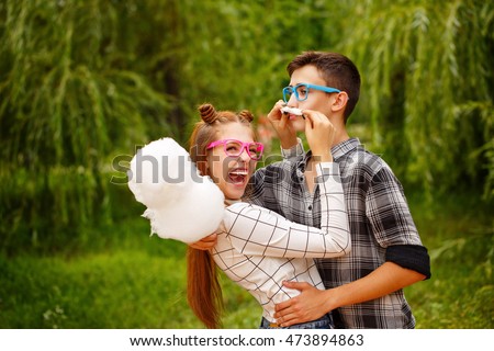 https://thumb1.shutterstock.com/display_pic_with_logo/2017265/473894863/stock-photo-enamoured-teenagers-eat-cotton-candy-girlfriend-and-boyfriend-together-they-wear-glasses-she-473894863.jpg