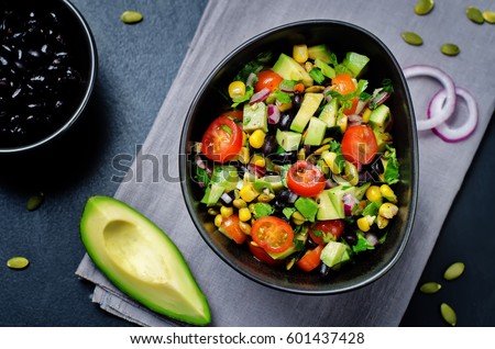 Black beans corn avocado red onion tomato salad with lime dressing. toning. selective focus