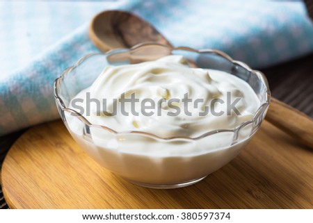 Greek yogurt on wooden background