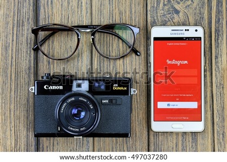 BANGKOK, THAILAND - 7 OCTOBER 2016: Samsung A5 Smartphone display instagram application on the screen and Canon A35 vintage film camera, Instagram is a photo-sharing app for smartphone.