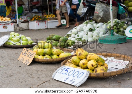 Vinh Long, Vietnam - Nov 30, 2014: Tropical fruits displayed on bamboo baskets at Vinh Long fruit market, Mekong delta. The price is surprisingly cheap