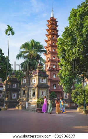 Hanoi, Vietnam - Aug 23, 2015: Yard panoramic view of Tran Quoc temple with women wearing traditional dress Ao Dai visiting the temple. Tran Quoc is the oldest temple in Hanoi