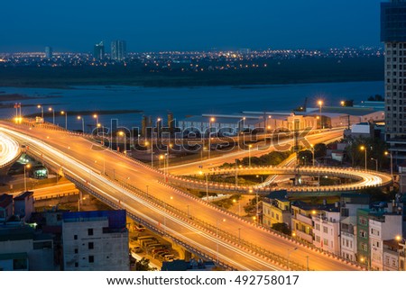 Hanoi cityscape. Aerial view of enter way to Vinh Tuy bridge at twilight