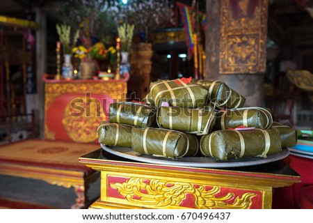 Chung cake on altar in old village communal house. Cooked square glutinous rice cake, Vietnamese lunar new year food