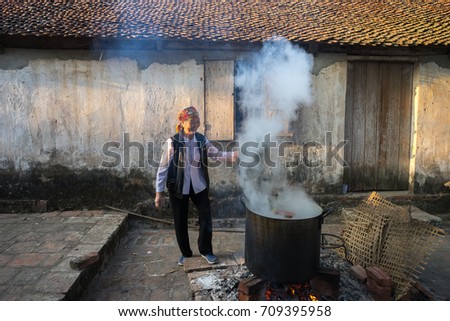 Hanoi, Vietnam - Jun 22, 2017: Cooking Chung cake outdoor in communal house at So village, Quoc Oai district. , square glutinous rice cake, Vietnamese lunar new year food