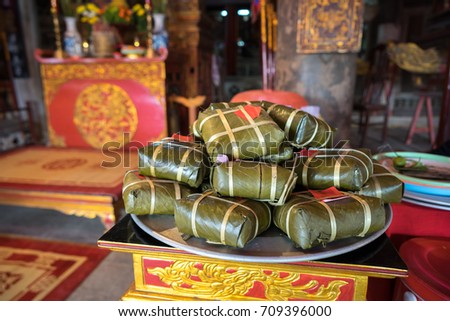 Chung cake on altar in old village communal house. Cooked square glutinous rice cake, Vietnamese lunar new year food