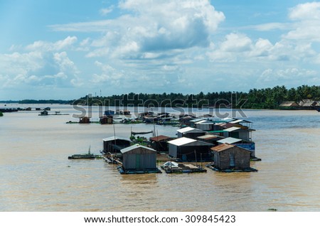 Ben Tre, Vietnam - August 11, 2015: floating homes on the Tien Giang River in the province of Ben Tre, in the Mekong Delta region of southern Vietnam.