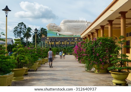 My Tho, Vietnam - August 11, 2015: Large reclining Buddha statue in Vinh Trang Temple, a 19th century Buddhist temple in My Tho in the province of Tien Giang.