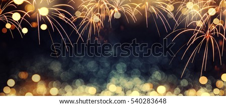 Gold and dark blue Fireworks and bokeh in New Year eve and copy space. Abstract background holiday.