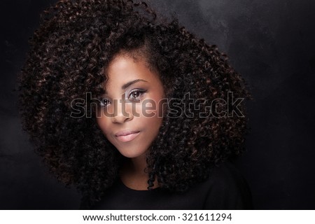 Closeup beauty portrait of young african american girl with afro and glamour makeup.