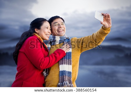 https://thumb1.shutterstock.com/display_pic_with_logo/2114402/388560154/stock-photo-older-asian-couple-on-balcony-taking-selfie-against-road-leading-out-to-the-horizon-at-night-388560154.jpg
