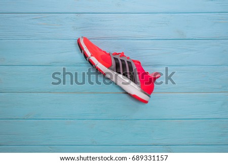 Kiev, Ukraine - July 2, 2017: Adidas Running boots. Adidas, multinational company. Blue background. Product shots. New model of shoes, modern aerodynamic design, light and beautiful sneakers.