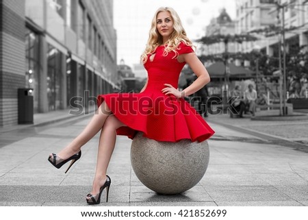 https://thumb1.shutterstock.com/display_pic_with_logo/2126642/421852699/stock-photo-beautiful-blonde-woman-in-red-dress-and-high-heels-is-sitting-outdoor-on-the-stone-sphere-at-black-421852699.jpg