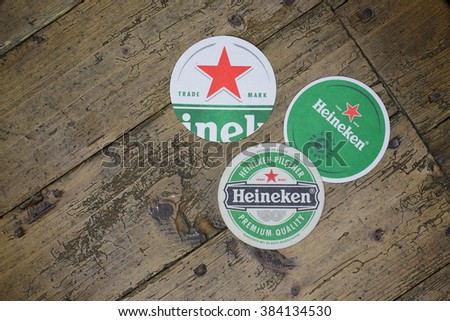 VELKE KARLOVICE, CZECH -July 10,2015: Berrmats from Heineken Lager Beer in vintage background , it was first brewed by Gerard Adriaan Heineken in 1873