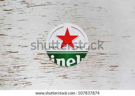 AMELAND, Holland -OCTOBER 1,2016: Berrmats from Heineken Lager Beer in vintage background , it was first brewed by Gerard Adriaan Heineken in 1873