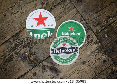 AMSTERDAM, HOLLAND - April 24, 2016.: Beer mats from Heineken Lager Beer in vintage background , it was first brewed by Gerard Adriaan Heineken in 1873