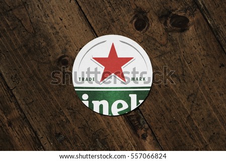 AMSTERDAM, HOLLAND - April 24, 2016.: Beer mats from Heineken Lager Beer in vintage background , it was first brewed by Gerard Adriaan Heineken in 1873