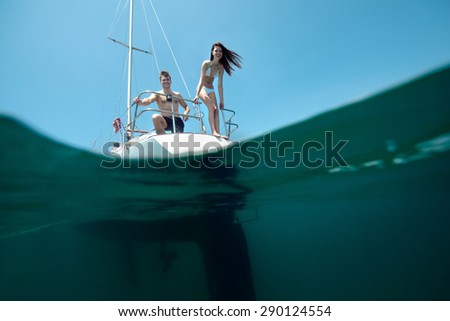 https://thumb1.shutterstock.com/display_pic_with_logo/2150849/290124554/stock-photo-ideal-beauty-young-laughing-couple-on-sailing-yacht-split-with-underwater-real-shoot-290124554.jpg