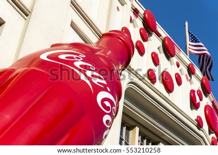 OSAKA - JAN 10: A big Coca-Cola logo on the wall and American Flag in Osaka on January 10. 2017 in Japan