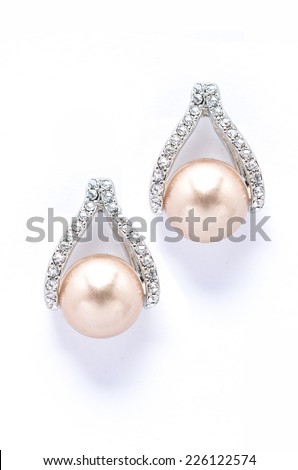 Earrings with pearls and diamonds on white background