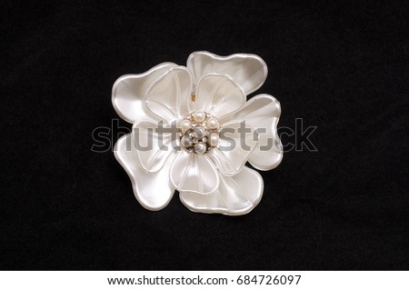 Brooch flower with pearls isolated on black
