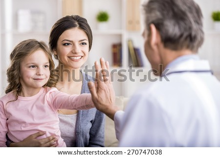 Little girl with her mother at a doctor on consultation.