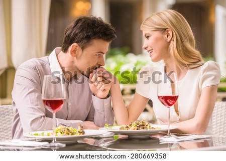 https://thumb1.shutterstock.com/display_pic_with_logo/2181548/280669358/stock-photo-young-smiling-couple-enjoying-the-meal-in-gorgeous-restaurant-and-drinking-wine-man-kissing-woman-280669358.jpg