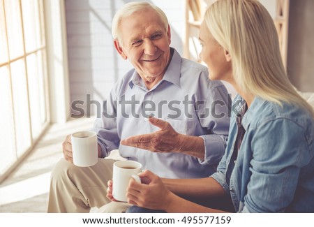 https://thumb1.shutterstock.com/display_pic_with_logo/2181548/495577159/stock-photo-handsome-old-man-and-beautiful-young-girl-are-drinking-tea-talking-and-smiling-while-sitting-on-495577159.jpg