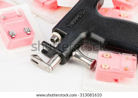 Rostov - on - Don, Russia - September 4, 2015:  Professional body piercing instruments: piercing gun and earring. Studex - Universal Ear Piercing System made in the USA. - stock photo