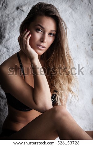 stock-photo-fashion-portrait-of-beautiful-female-model-posing-in-black-lingerie-near-white-wall-526153726.jpg