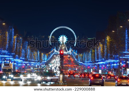 Avenue Champs-Elysees with Christmas illumination and ferris wheel at horizon in Paris, France. Champs-Elysees is one of the most famous streets in the world.
