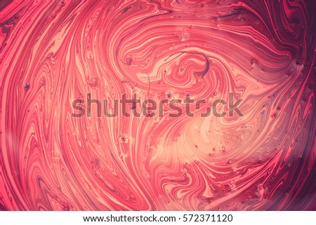 Different color oil paint. Oil paints tone Red abstract background. The flow of red oil.