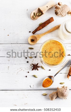 Top view image of turmeric latte and spices with copyspace