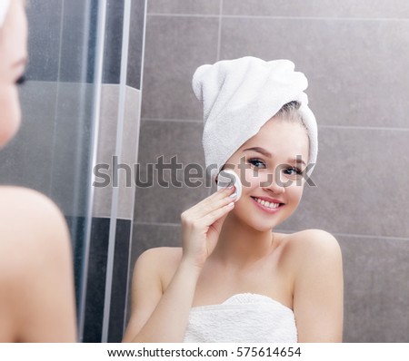 Nice yang girl with cotton pad in mirror