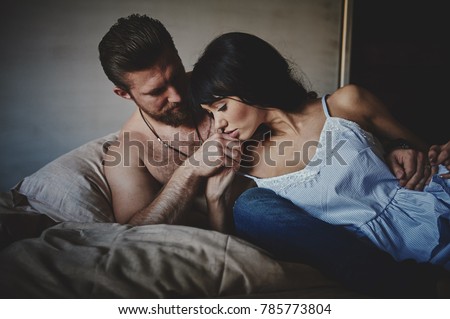 https://thumb1.shutterstock.com/display_pic_with_logo/2250527/785773804/stock-photo-strong-man-and-beautiful-woman-lying-on-the-bed-intimate-atmosphere-luxurious-furniture-and-785773804.jpg