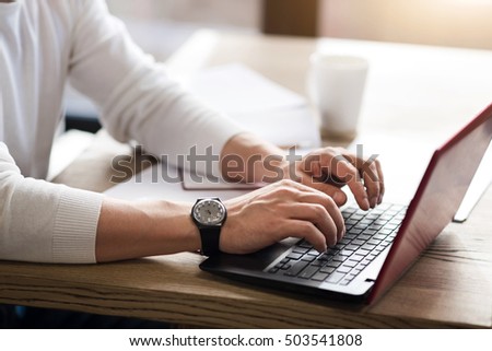 Close up of man typing on computer