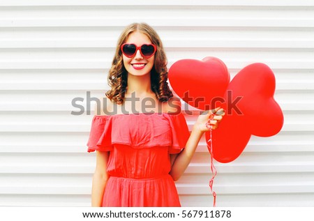 https://thumb1.shutterstock.com/display_pic_with_logo/2273876/567911878/stock-photo-happy-smiling-young-woman-in-red-dress-and-sunglasses-with-air-balloons-heart-shape-over-white-567911878.jpg
