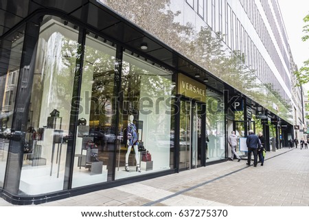 Dusseldorf, Germany - April 16, 2017: Versace store located in a modern building with people walking in Dusseldorf, Germany