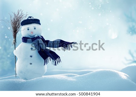 Merry christmas and happy new year greeting card with copy-space.Happy snowman standing in winter christmas landscape.Snow background