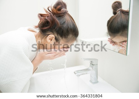 Woman wakes from sleep and she was cleansing the morning before shower
