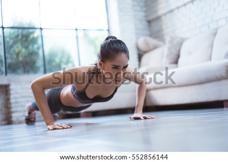 Asian women exercise indoor at home she is acted "push up"