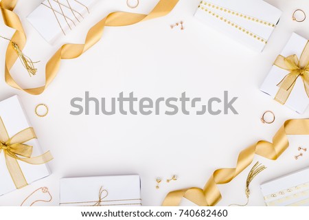 golden jewelry and gift boxes on white background with copy space for text. fashion and shopping concept. wedding, marriage or birthday composition. flat lay, top view