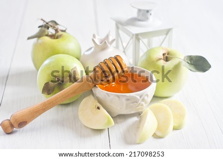 Apple and honey, traditional food of jewish New Year celebration, Rosh Hashana. Selective focus. High key.