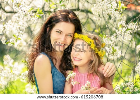 Mother and daughter in spring cherry blossom park