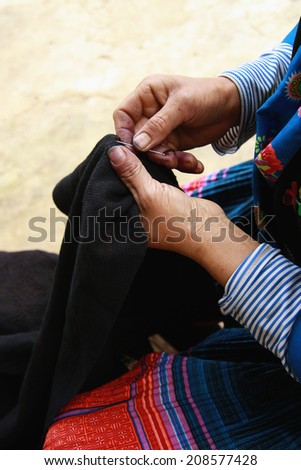 Dien Bien Phu, Dien Bien, Vietnam August 1, 2014: Drawing on dresses handmade in the suburbs of Hmong in Dien Bien Phu City, Dien Bien