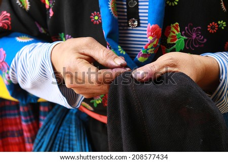 Dien Bien Phu, Dien Bien, Vietnam August 1, 2014: Drawing on dresses handmade in the suburbs of Hmong in Dien Bien Phu City, Dien Bien