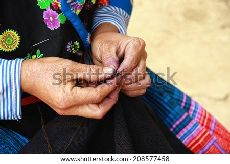 Dien Bien Phu, Dien Bien, Vietnam August 1, 2014: Drawing on dresses handmade in the suburbs of Hmong in Dien Bien Phu City, Dien Bien